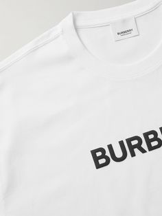 As much as we love Burberry for its more complex designs, the brand always nails the basics. This T-shirt is cut from white cotton-jersey in a relaxed fit and printed with the house's logo in contrasting black. Burberry Replica Shirt, Burberry Rebrand, Burberry Shirts For Men, White Designer Logo Short Sleeve T-shirt, Burberry Inspierd Shirt, Burberry T Shirt, Latest T Shirt, Burberry Men, Home Logo