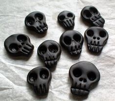 there are many black skulls on the table