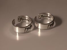 This Promise? Promise. Pinky Promise Ring Set is the perfect way to make a special vow to someone you love. Crafted from quality materials, the set features two matching rings, making it ideal for couples who want to express their commitment to one another. Show your devotion with this timeless pinky promise ring set. Product Details: Materials: Aluminum, Sterling Silver, Fine Silver, 14k Gold Filled Color: Silver, Gold, Rose Gold Size: 6mm Two Matching Rings You will receive two hand-stamped ri Adjustable Sterling Silver Wedding And Promise Rings, Couples Sterling Silver Jewelry For Promise, Adjustable Couples Promise Jewelry, Adjustable Couples Jewelry For Promise, Adjustable Engraved Promise Ring, Engraved Adjustable Couple Promise Rings, Adjustable Sterling Silver Couple Rings For Proposal, Adjustable Personalized Rings For Proposal, Personalized Adjustable Ring For Proposal