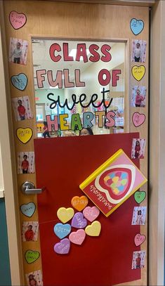 a classroom door decorated with heart shaped magnets and writing that says class full of sweet hearts