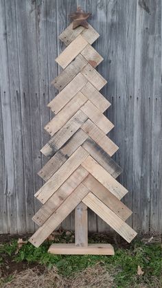 a wooden christmas tree made out of old pallets