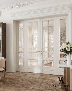 an elegant dining room with white walls and wooden floors