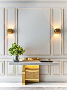 a vase with flowers sitting on top of a table in front of white wallpaper