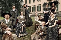 a group of people sitting on top of a grass covered field