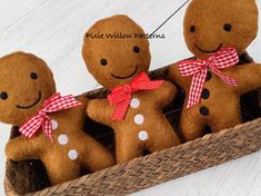 three gingerbread men are sitting in a basket