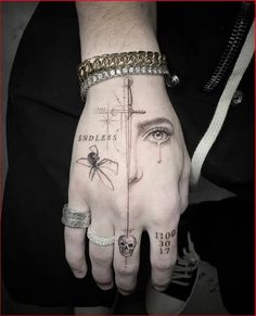 a person's hand with a tattoo on it and a cross in the middle