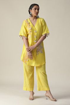 Yellow tunic featuring side patchwork pattern, embellished by beads, mirror, tassels and embroidered mandala motifs. Comes with striped pant. - Aza Fashions V-neck Cotton Kurta With Resham Embroidery, Festive V-neck Palazzo Set With Chikankari Embroidery, Traditional V-neck Palazzo Set With Resham Embroidery, Traditional Embroidered V-neck Palazzo Set, Embroidered V-neck Traditional Wear For Navratri, V-neck Mirror Work Set For Festivals, V-neck Sets With Mirror Work For Festivals, V-neck Festival Sets With Mirror Work, Designer Embroidered V-neck Kurta