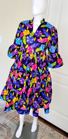 This stunning African Print Women kaftan dress is a must-have for anyone looking to add some comfortable and yet stylish look to their wardrobe. The dress boasts a beautiful geometric pattern and features a round neckline,  a half sleeves and a little ruffled sleeves for a chic touch. The button closure adds convenience, while the ruffle accents give it a playful flair. Perfect for any occasion, this dress is suitable for wedding guest, holy communion, and semi casual wear. It's made from a soft and comfortable blend of polycotton and is machine washable for easy care. The dress is handmade and comes in a size S, M, L, XL, and XXL. a midi length dress that's ideal for summer, fall, and spring seasons. Care instructions: no bleaching, wash with likes colors on a gentle circle, dry on low to Multicolor Floral Print Dress With 3/4 Sleeves, Bohemian Short Sleeve Dress With Colorful Pattern, Patterned Summer Dresses With 3/4 Sleeve, Patterned 3/4 Sleeve Summer Dresses, Printed Half Sleeve Dresses For Vacation, Printed Half Sleeve Vacation Dresses, Multicolor Printed Half Sleeve Dress, Bohemian Dress With Tropical Print, Bohemian Patterned Dresses With Tropical Print