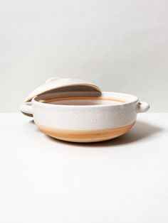 a white and brown bowl sitting on top of a table