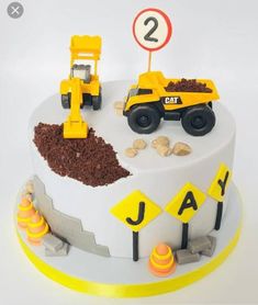 a birthday cake with construction vehicles on it