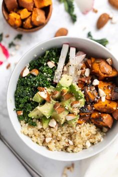 a white bowl filled with rice, broccoli and sweet potato salad on top of a table