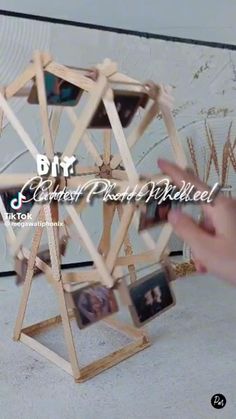 a wooden structure with pictures hanging on it's sides and the words diy