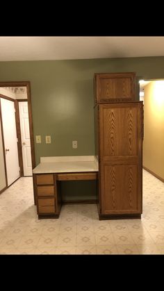 an empty room with a desk and cabinets