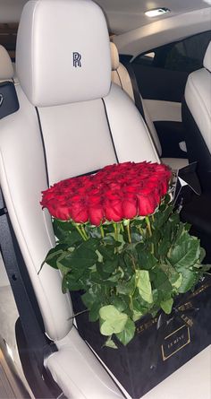 a bunch of roses sitting in the back seat of a car