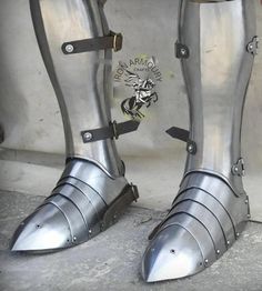 two metal boots with spikes on them sitting next to each other