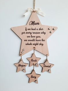 a wooden star hanging on the wall with some stars attached to it's sides