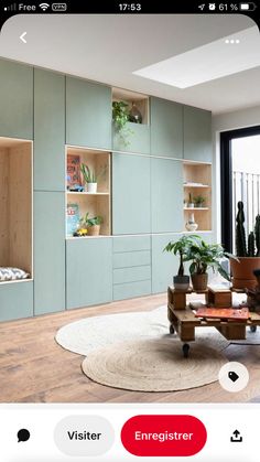 a living room filled with furniture and plants