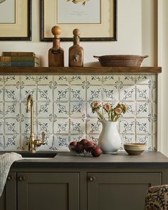 a kitchen counter with flowers and fruit on it