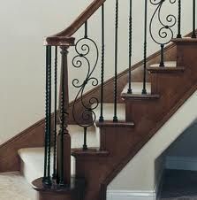 a staircase with wrought iron handrails and carpet