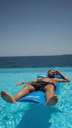 a man laying on an inflatable pool float