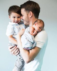 a man holding a baby in his arms