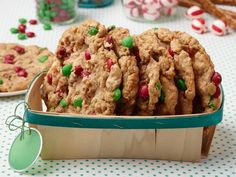 some cookies are in a box on a table with candy canes and candies