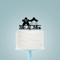 a wedding cake topper with the bride and groom on it's tiered cake