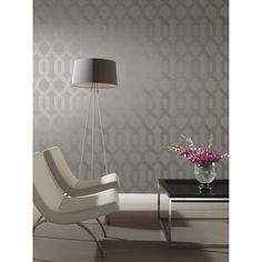 a modern living room with grey wallpaper and white chair next to a coffee table