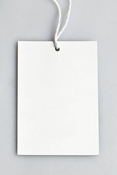 an empty white paper hanging from a string