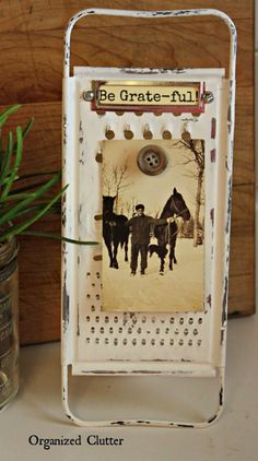 an old tin can with a picture on it next to a vase filled with flowers