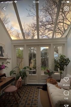 a living room filled with furniture and lots of windows