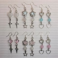 six pairs of dangling earrings with hearts and stars