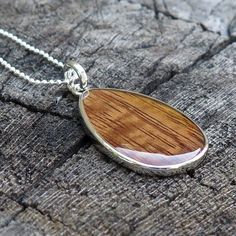 "Pendant size: 41mm x 24mm Thickness: 3mm Metal: Rhodium Plated on Brass Material: Genuine Hawaiian Koa Wood 18\" Silver-Colored Box Chain Included" Sterling Silver Brown Necklace For Gift, Polished Teardrop Pendant Necklace For Gift, Brown Sterling Silver Teardrop Necklace, Teardrop Pendant Necklace With Polished Finish For Gifts, Teardrop Pendant Necklace With Silver Chain For Gifts, Brown Teardrop Sterling Silver Necklace, Silver Chain Necklace With Teardrop Pendant For Gift, Teardrop Necklace With Polished Finish As Gift, Teardrop Polished Finish Necklace For Gift