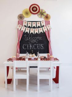 a welcome to the circus sign on a chalkboard with red, white and blue decorations