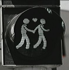 a black and white photo of a pedestrian crossing sign