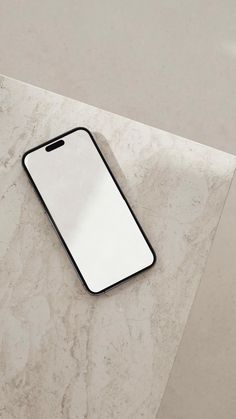 an iphone sitting on top of a marble table