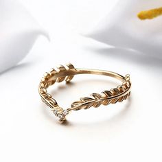 ✦ Add a touch of elegance to your jewelry collection with this S925 Dainty Gold Feather CZ Ring. The intricate feather design is crafted in gold-tone metal and adorned with shimmering CZ stones, creating a timeless and sophisticated look. Whether you're looking for a stackable ring or a standalone piece, this ring is sure to impress. ----------- DESCRIPTIONS -----------▪ Gemstone: Cubic Zirconia▪ Stone Shape: Round▪ SKU: TB572▪ Material: 925 Sterling Silver▪ Plating: 14K Gold Vermeil ----------- June Meaning, Mismatched Earrings Studs, Feather Ring, Basic Jewelry, Gold Feathers, Nose Rings Hoop, Improve Focus, Crystal Hoop Earrings, Climber Earrings