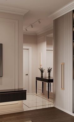 a living room with white walls and black furniture