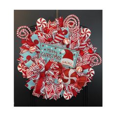 a christmas wreath with candy canes and santa's hat