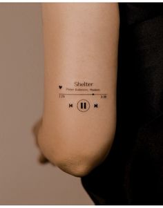 a woman's arm with an audio player tattoo on her left forearm and ear