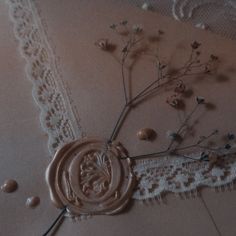 a close up of a piece of cloth with flowers on it and lace around the edges