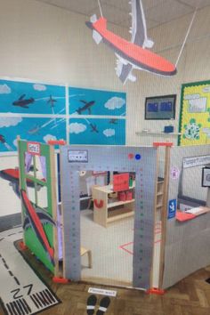 an airplane is flying over the children's play area in this room with wooden flooring