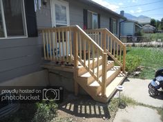 a baby stroller parked in front of a house with stairs leading up to the porch