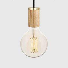 a light bulb that has been turned on and is hanging from the ceiling with three lights