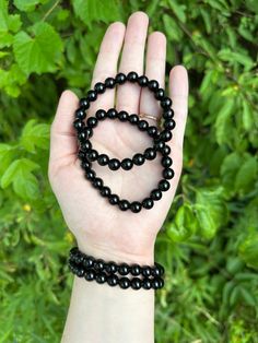 This listing is for one (1) Black Obsidian bracelet. You will receive ONE bracelet. I will intuitively choose your bracelet for you.  Each bracelet has 8mm beads and is roughly 7in and does stretch. These should fit a standard wrist.  BLACK OBSIDIAN:  This is a very powerful stone that can help to ground you. It helps you to work through your shadow work, and then release all the negative energies. It works to repel negative energies and disperse unloving thoughts.  Chakra: Root Element: Fire Astrological Signs: Libra and Scorpio  🌙 This is natural Obsidian, and all of its patterns and colors are unique and natural. Any blemishes are natural. 🌙 I always choose the best quality crystals for you to shop, always with the greatest energy.  🌙 Your purchase will arrive to you cleansed and rea Black Obsidian Bracelet, Obsidian Jewelry, Obsidian Bracelet, Black Obsidian, Shadow Work, Astrology Signs, Crystal Items, Arm Band, Bead Charms