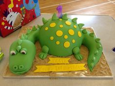 a birthday cake with a green and yellow dragon on it