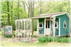 a small blue house in the woods