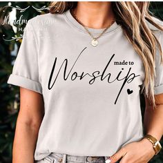 a woman wearing a t - shirt with the words made to worship printed on it