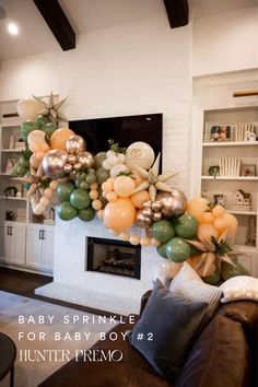 a baby sprinkle balloon arch in a living room