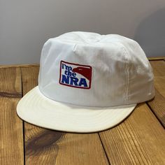 Vintage USA Made I'm The NRA Trucker Hat 1980s 1990s Snapback Cap Circa: 1980's - 1990's Description: "I'm The NRA" Embroidered Trucker Hat. Made in the USA. Size: Snapback - Tagged: One Size Fits ALL - Adult Condition: Shows some light wear. Snapback is in good shape(see pics). Colors are good with some discoloration on the top and bottom of the brim(see pics). Brim is not broken and flat but has some discoloration to the top and bottom(see pics). Sweatband shows light wear and some light disco Vintage White Baseball Cap With Curved Brim, Vintage White Dad Cap, Vintage White 5-panel Trucker Hat, Vintage White 5-panel Baseball Cap, Vintage White Cotton Dad Hat, White Retro Snapback Hat With Embroidered Logo, Retro White Dad Hat, Vintage White Dad Hat, Vintage White Baseball Cap